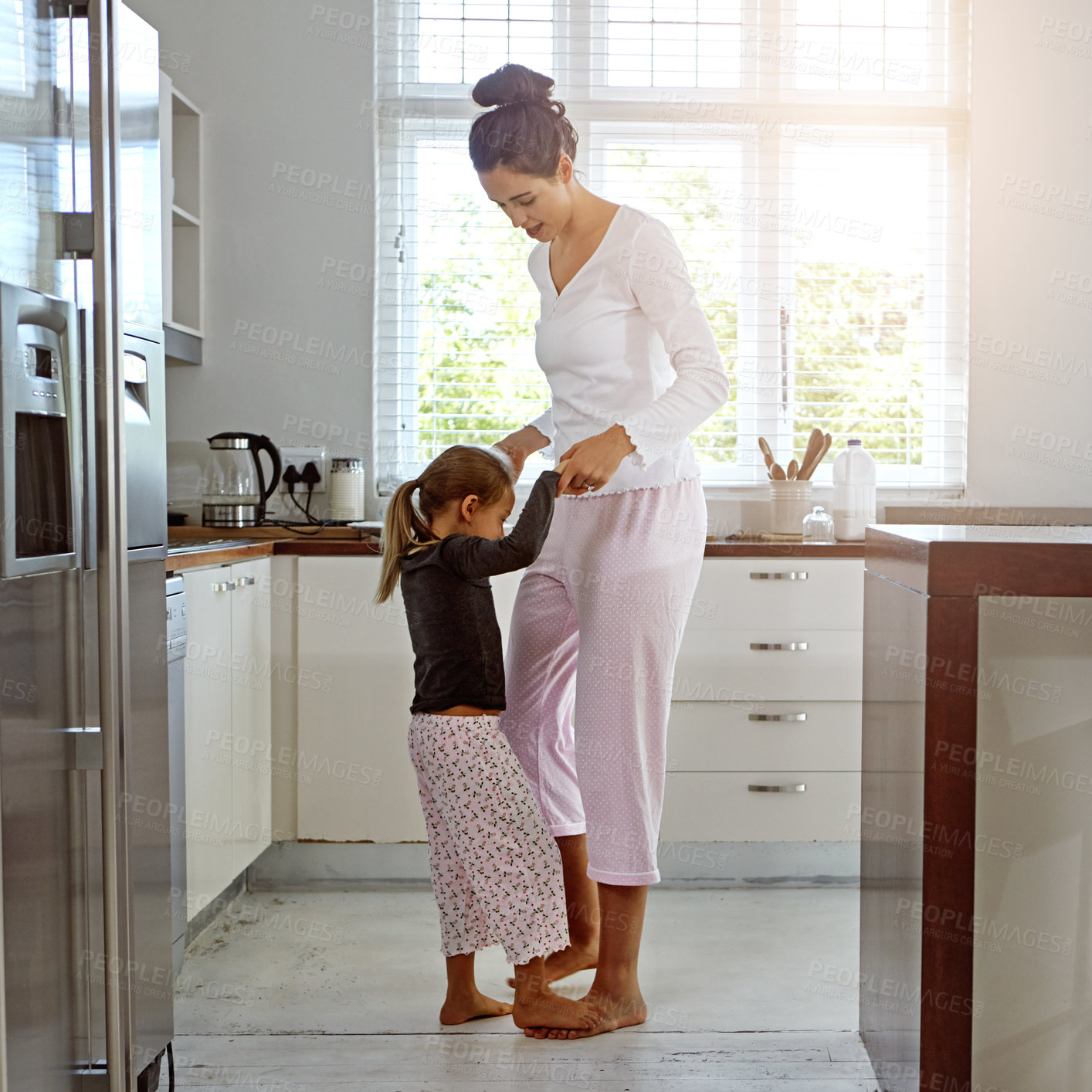 Buy stock photo Dance, love and mother with girl in kitchen play, fun and bonding, happy and relax in their home. Mom, daughter and dancing in their house, morning and playing while enjoying free day on the weekend