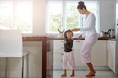 Buy stock photo Kitchen dance, mom and girl in the morning at home with happiness dancing together. Mom, child and mama care holding hands with a young kid in a house happy about funny family with a smile  