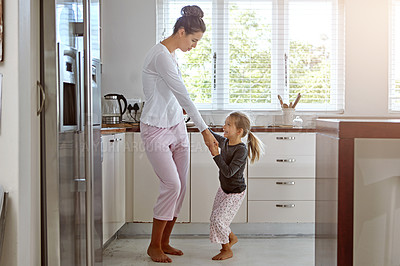 Buy stock photo Kitchen dancing, mother and daughter in the morning at home with happiness dancing together. Mom, girl and parent care holding hands with a young kid in a house happy about family with a smile  