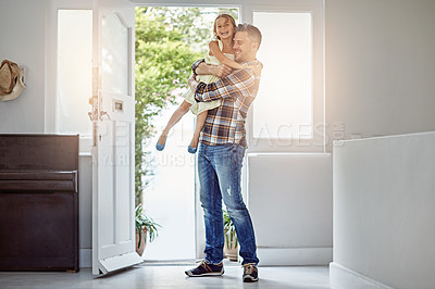 Buy stock photo Shot of a father picking up his daughter as he enters his house