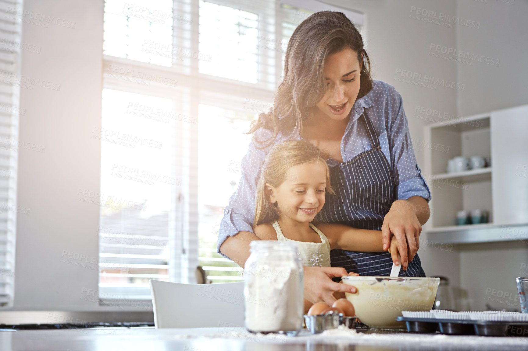 Buy stock photo Mother, child and baking support in kitchen with fun learning, culinary skills and teaching cake recipe. Family, woman and happy girl with ingredients preparation for cooking, bonding and cookie mix