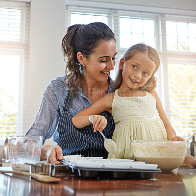 Buy stock photo Cropped shot of a mother and her daughter baking in the kitchen