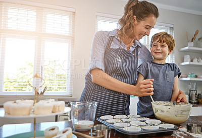 Buy stock photo Shot of a mother and her son baking something in the kitchen