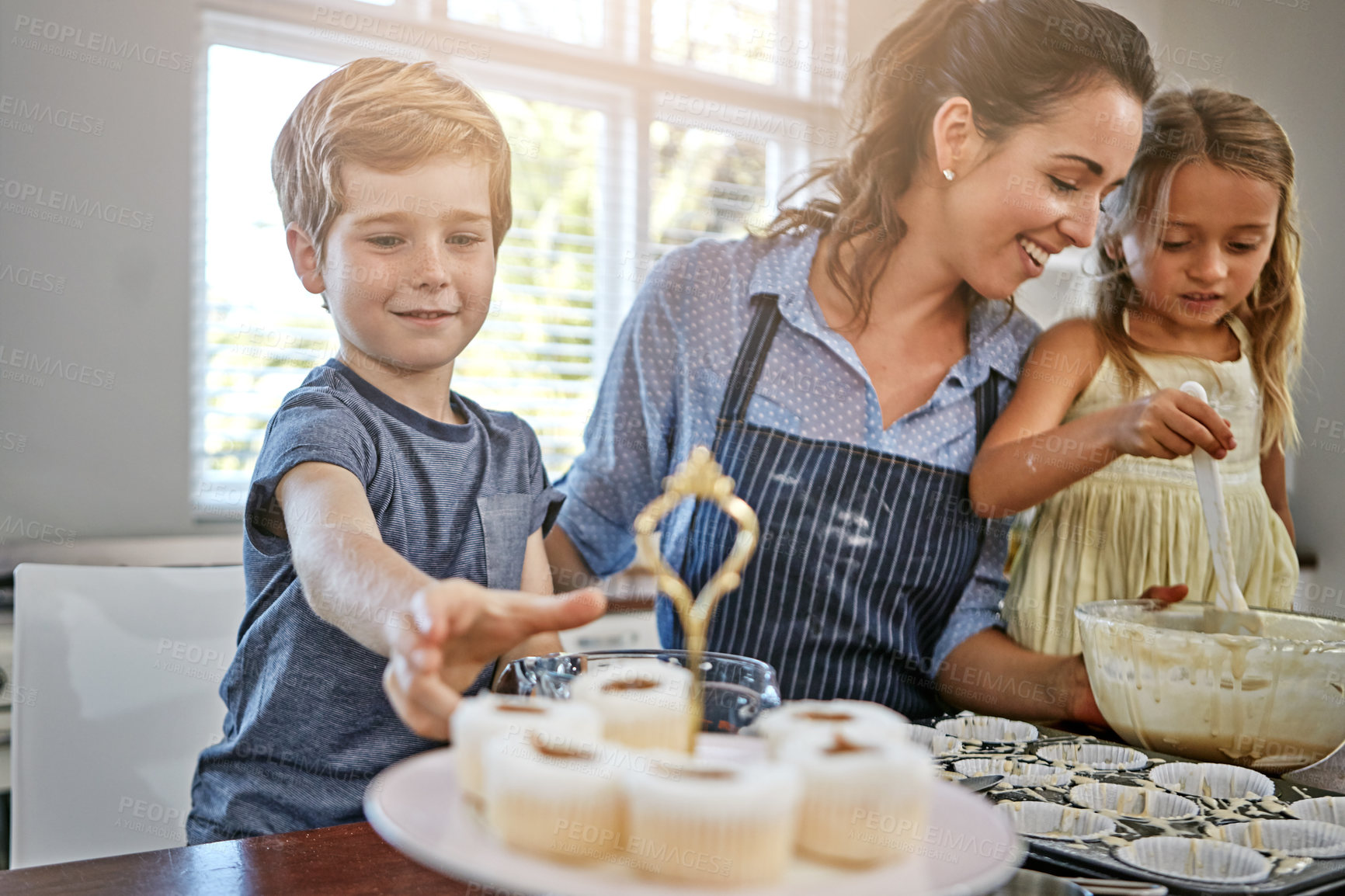 Buy stock photo Kids, cupcake or baking with mom, smile and help for bonding or dessert recipe in home. Boy, girl or mother teaching happy child cooking skills for development, learning or siblings with mixing bowl