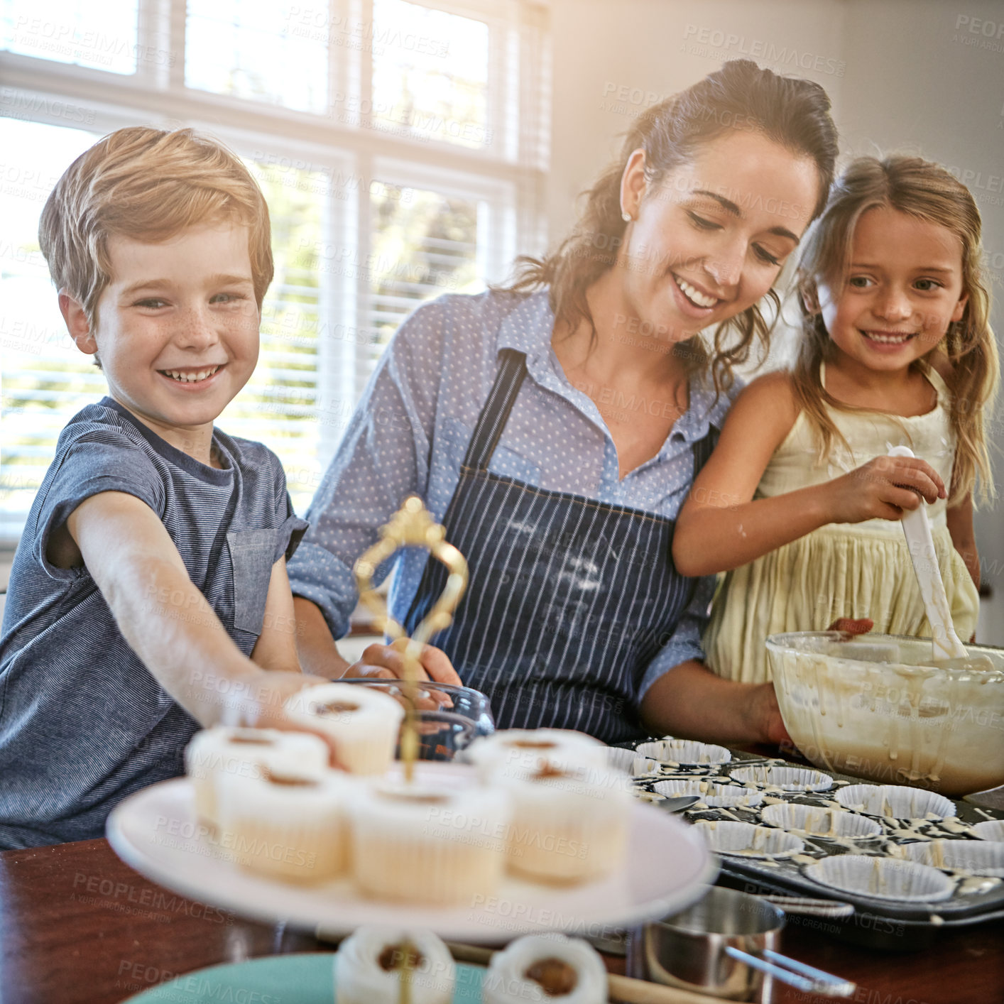 Buy stock photo Children, cupcake or baking with mom, smile or help for bonding or dessert recipe in home. Boy, girl or mother teaching happy kids cooking skills for development, learning or siblings by mixing bowl