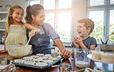 Buy stock photo Shot of a mother baking in the kitchen with her daughter and son