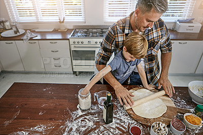 Buy stock photo Shot of a father and his son making pizza at home