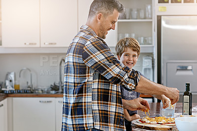 Buy stock photo Baking, dad and bonding with child, pizza and happy with son in kitchen, teaching and ingredients. Home, learning and help for father, meal prep and parent with boy, dinner and recipe for food