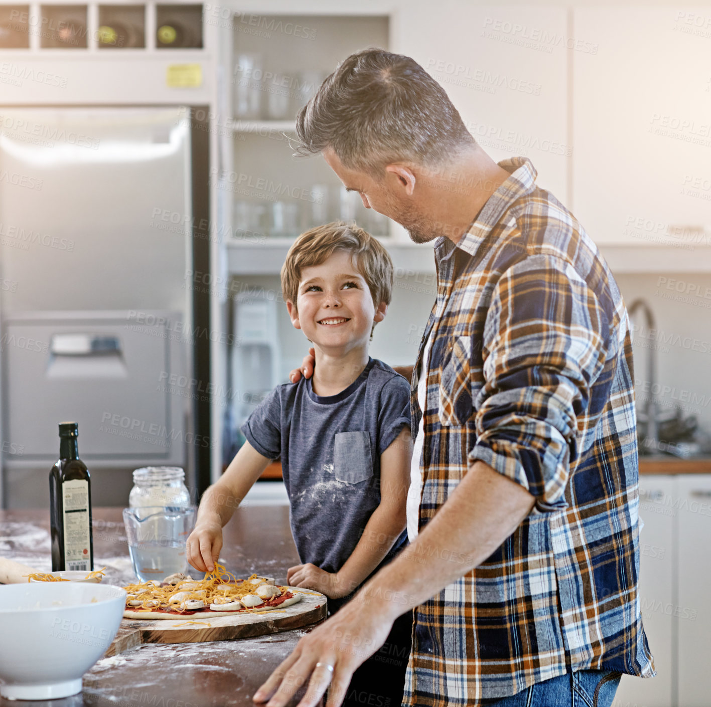 Buy stock photo Happy, dad and cooking with child, pizza and meal prep with son in kitchen, teaching and ingredients. Home, learning and help for father, bonding and parent with boy, dinner and recipe for food