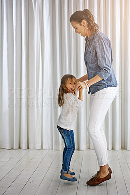Buy stock photo Dance, family and mother with girl in a living room for fun, bonding and teaching dancing steps in their home. Love, mom and daughter playing, laughing and relax in their lounge, weekend and positive