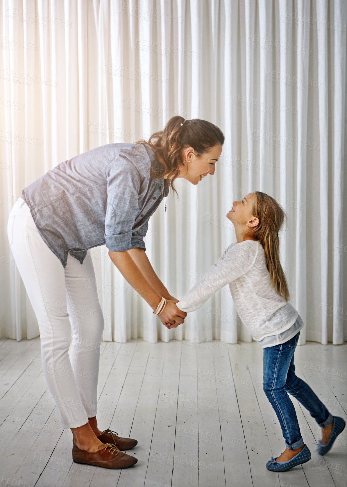 Buy stock photo Happy, family and mom with girl at home holding hands to show love, care and happiness. Lens flare, mother and kid together having fun in a house laughing, playing and holding hand with parent