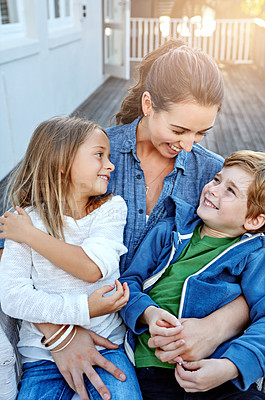 Buy stock photo Shot of a happy mother spending time with her son and daughter outdoors