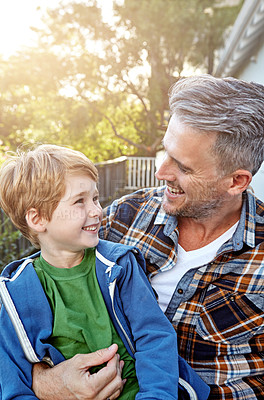 Buy stock photo Shot of a happy father and son spending time outdoors