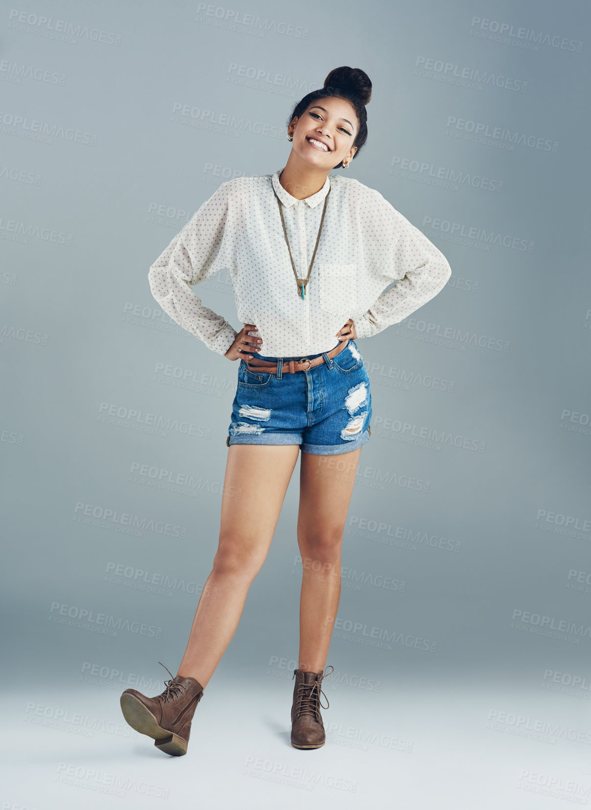 Buy stock photo Studio portrait of an attractive young woman posing against a gray background