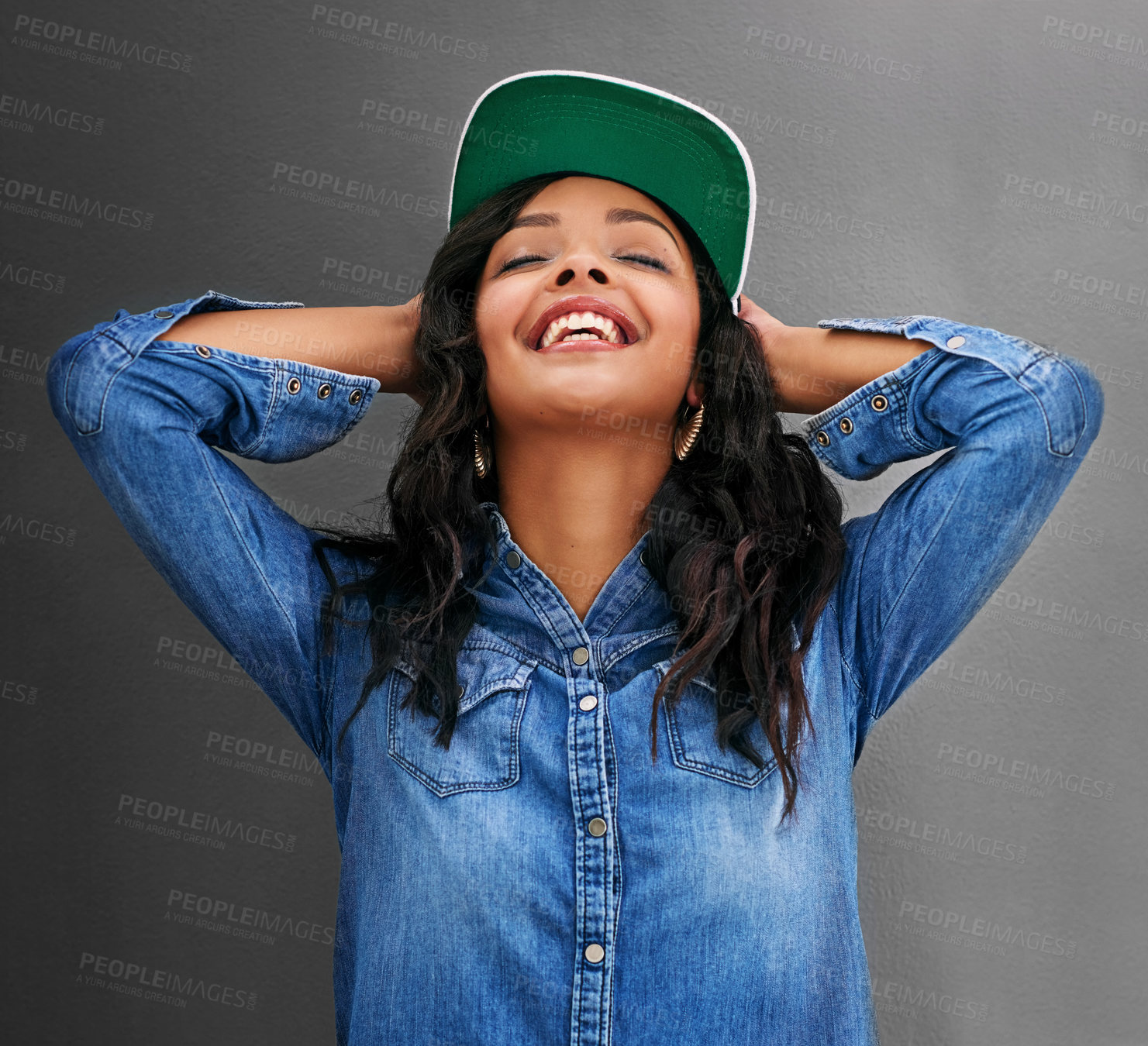 Buy stock photo Studio shot of an attractive young woman posing against a gray background