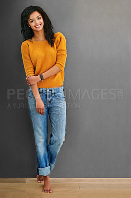 Buy stock photo Studio shot of an attractive young woman posing against a gray background