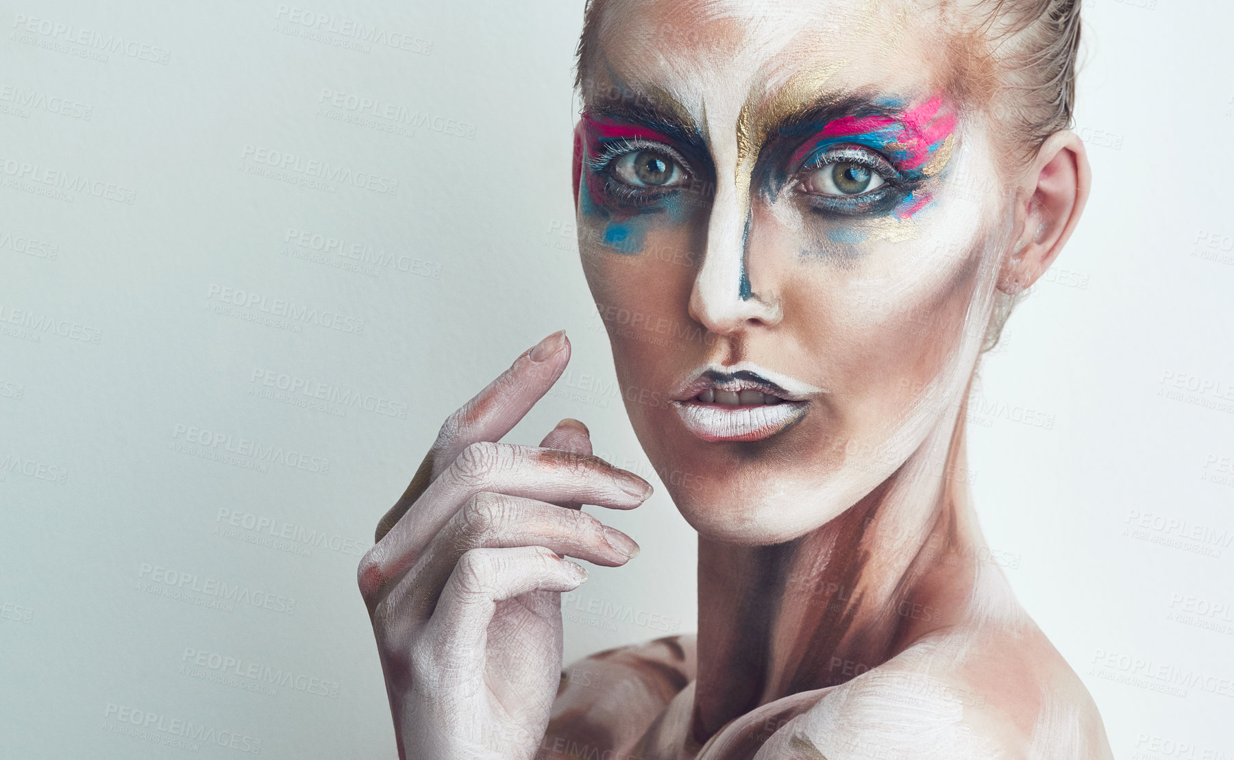 Buy stock photo Studio portrait of a young woman posing with paint on her face