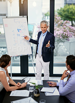 Buy stock photo Shot of a businessman giving a presentation to colleagues in an office
