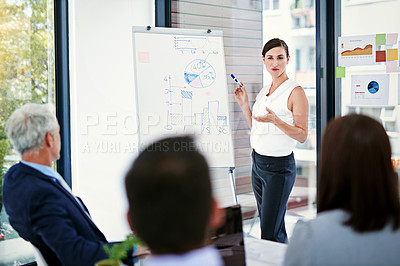 Buy stock photo Shot of businesswoman giving a presentation to colleagues in an office