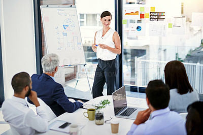 Buy stock photo Shot of businesswoman giving a presentation to colleagues in an office