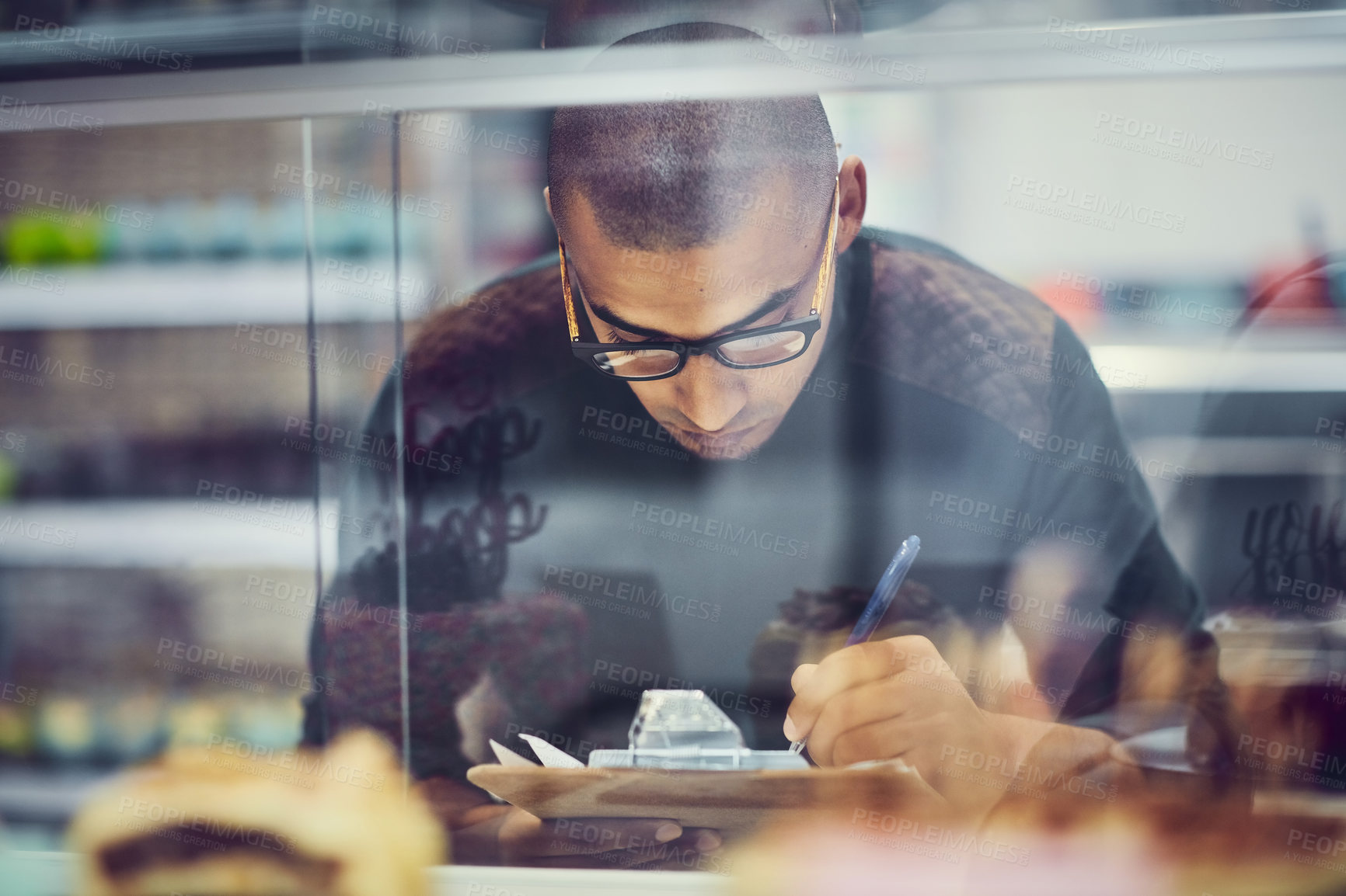 Buy stock photo Business, man and writing on clipboard at cafe for inventory management, stock checklist and quality control. Male owner, glasses and paperwork for food logistics, bakery schedule and retail invoice 