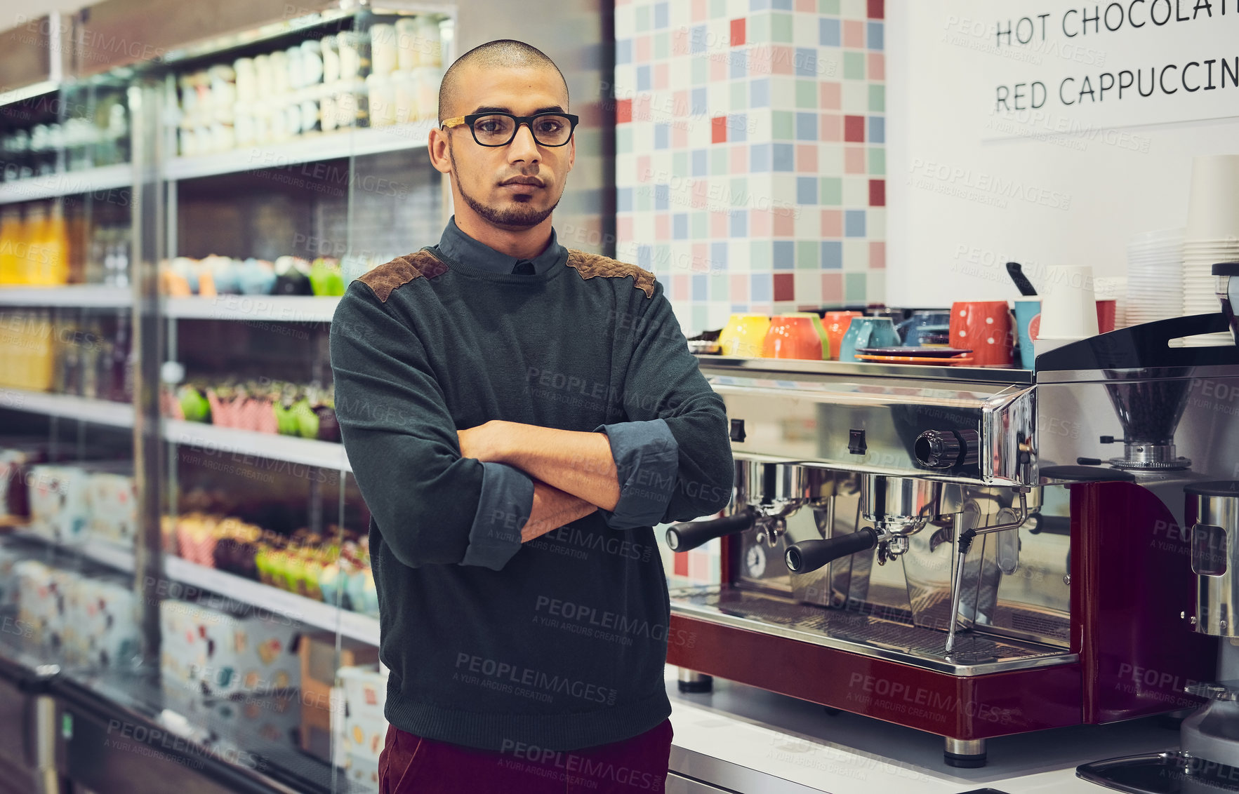 Buy stock photo Shot of a young man standing in a coffee shop