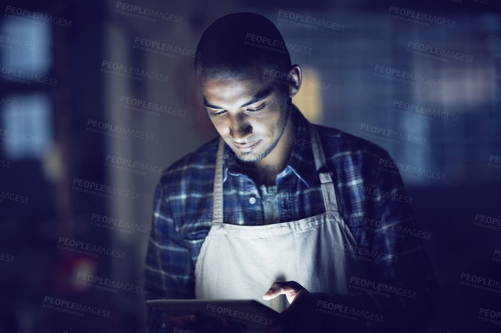 Buy stock photo Small business, night and man with apron, tablet and website info with typing, connection and startup. Person, entrepreneur and barista with technology, evening and communication with coffee shop