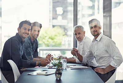 Buy stock photo Portrait of a group of businessmen having a meeting around a table in an office
