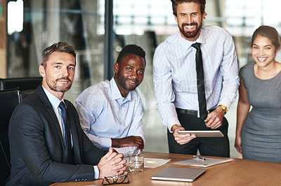 Buy stock photo Portrait of a group of corporate colleagues working together on a digital tablet in an office