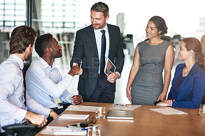 Buy stock photo Shot of a group of corporate colleagues working together in a boardroom