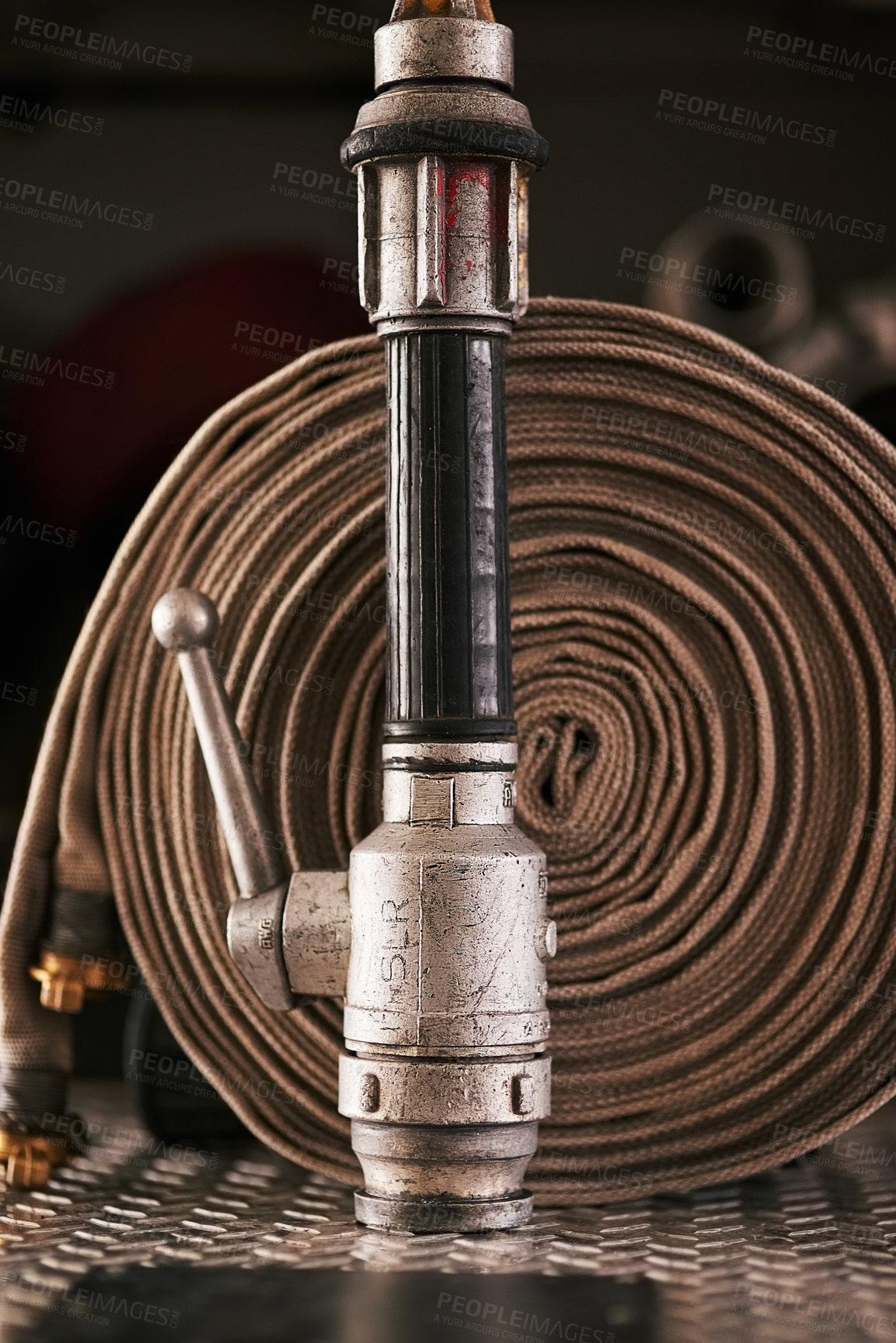 Buy stock photo Emergency, equipment and pipe with fire hose for security, danger or health and safety at station. Closeup of gear, tools or pressure extinguisher ready for rescue, service or firefighting operation