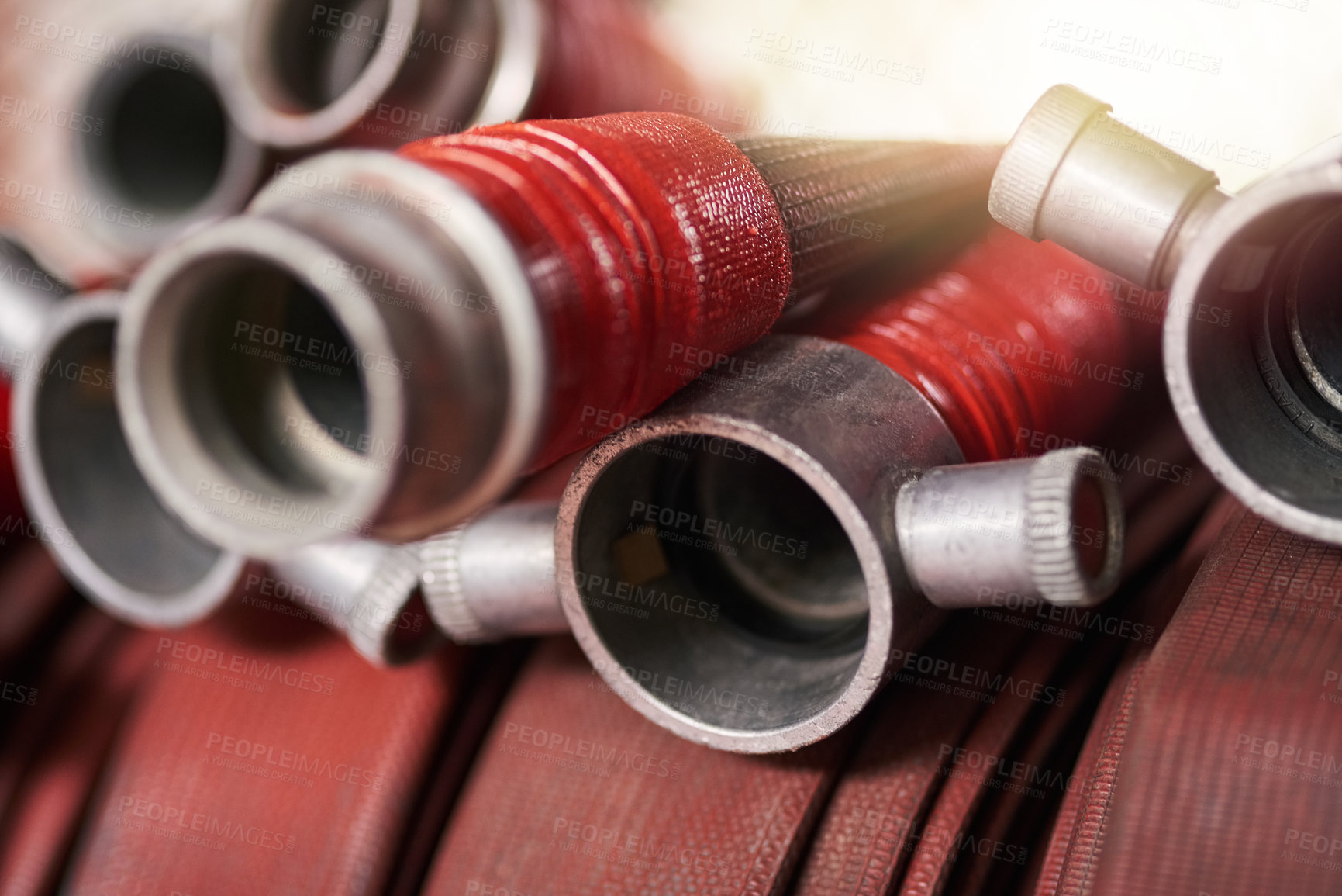 Buy stock photo Cropped shot of coiled fire hoses