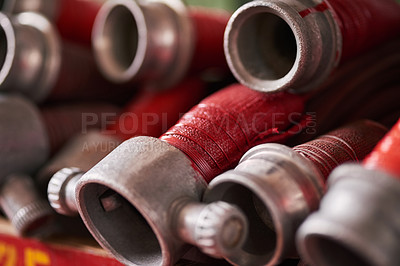 Buy stock photo Cropped shot of coiled fire hoses