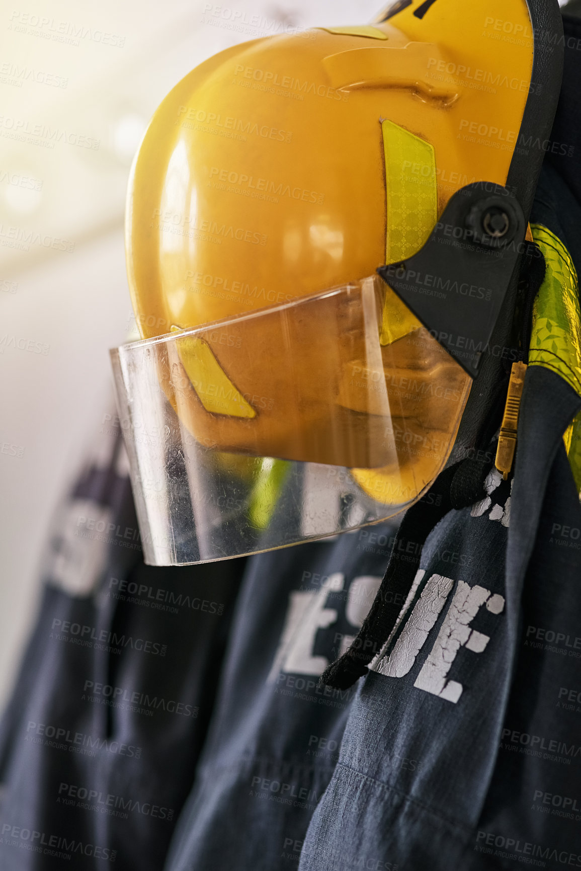 Buy stock photo Uniform, helmet and clothes of firefighter on wall for rescue, emergency service and protection. Fire brigade, safety gear and equipment, outfit and ppe on rack for health department in station