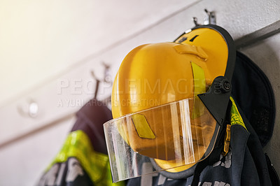 Buy stock photo Helmet, clothes and fire fighter for safety gear in emergency service, security and hero, courage or risk. Rescue uniform in department with protection and ppe on hanger, ready for danger or accident