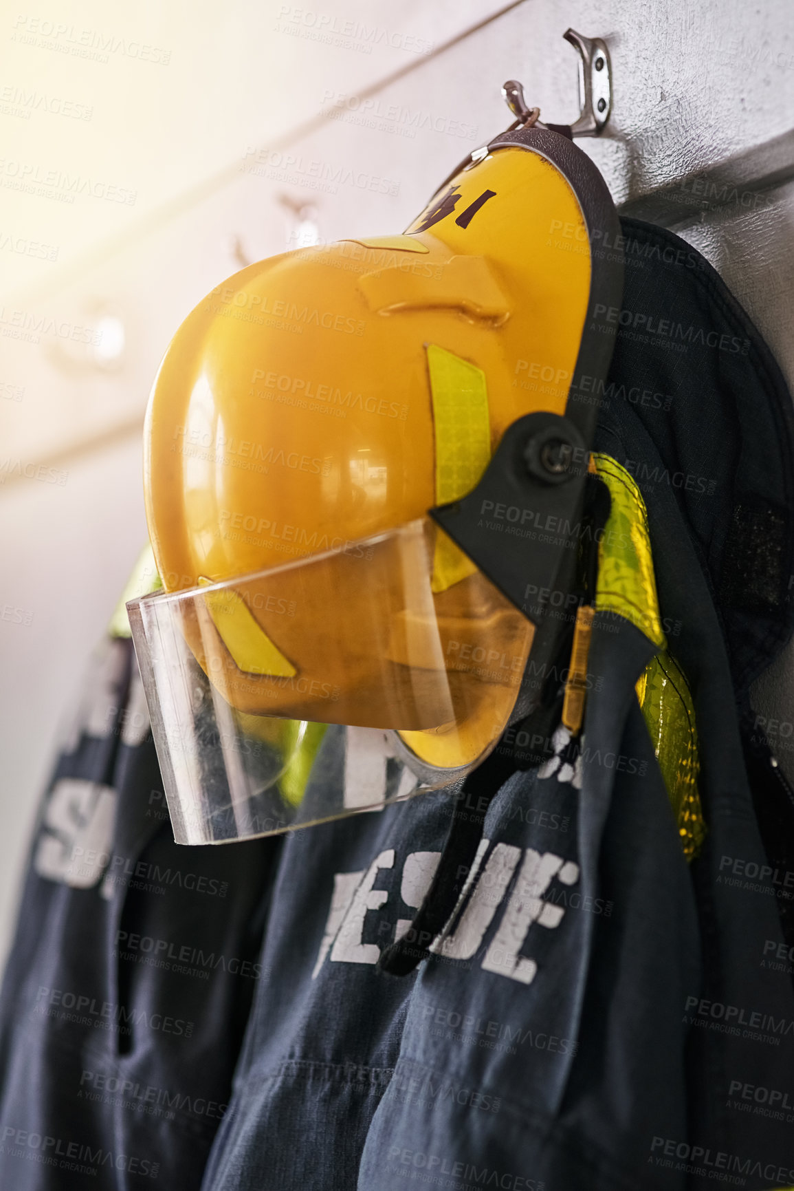 Buy stock photo Uniform, helmet and jacket of firefighter on wall for rescue, emergency service and protection. Fire brigade, safety gear and equipment, outfit and ppe on rack for health department in station