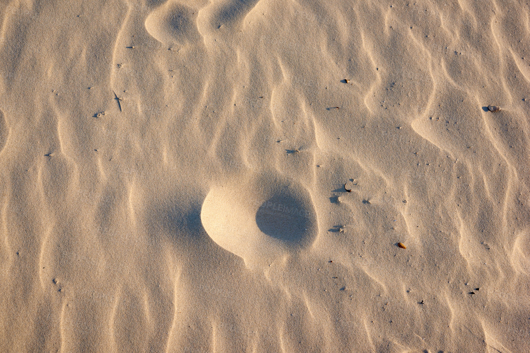 Buy stock photo Closeup of sand texture on a beach in summer as background. Brown desert pattern from tropical beach. Desert sand dunes texture. Rippled shore with tiny stones