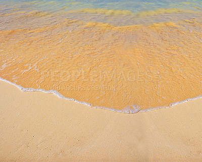 Buy stock photo An ocean with soft waves on a sandy beach with copy space. Beautiful clean sand on the coast, summer nature background and outdoor daylight. The ocean current creating high and low tides on the shore