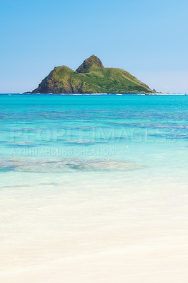 Buy stock photo Landscape view of mountain island, clear blue ocean water and a white sandy beach with copyspace. Remote scenery or scenic private beach. Travel overseas, tourism abroad, holiday or vacation