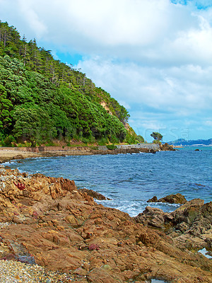 Buy stock photo Seascape, island and rock with beach and ocean for environment, travel destination and tropical. Summer vacation, water and nature with sea horizon for mediterranean coastline, holiday and paradise