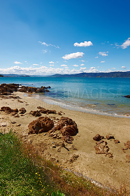 Buy stock photo Landscape, sand and rock with beach and ocean for environment, travel destination and tropical. Summer vacation, water and nature with sea horizon for mediterranean coastline, holiday and paradise