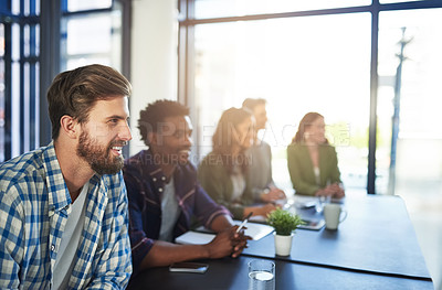 Buy stock photo Shot of a group of colleagues sitting in a boardroom meeting