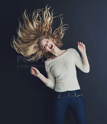 Buy stock photo Studio portrait of a smiling young woman isolated on black