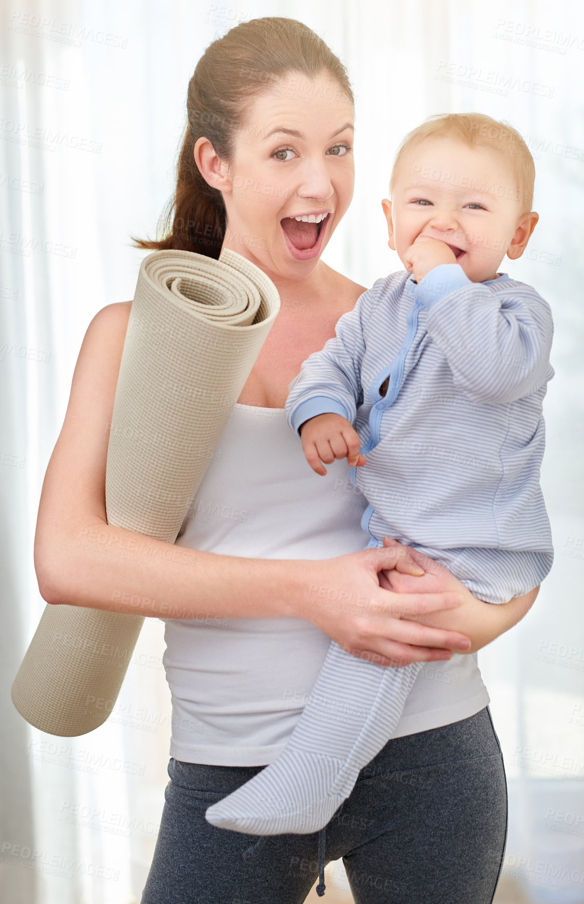 Buy stock photo Shot of a young woman working out while spending time with her baby boy