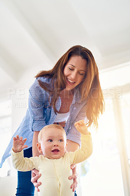 Buy stock photo Shot of a baby learning to walk with the help of his mother