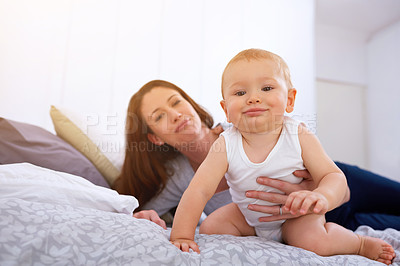 Buy stock photo Mother, baby or bed with learning and development for motor skills, growth with play and fun. Woman, newborn and hand for safety or care on soft mattress, teaching and trust in home with happiness