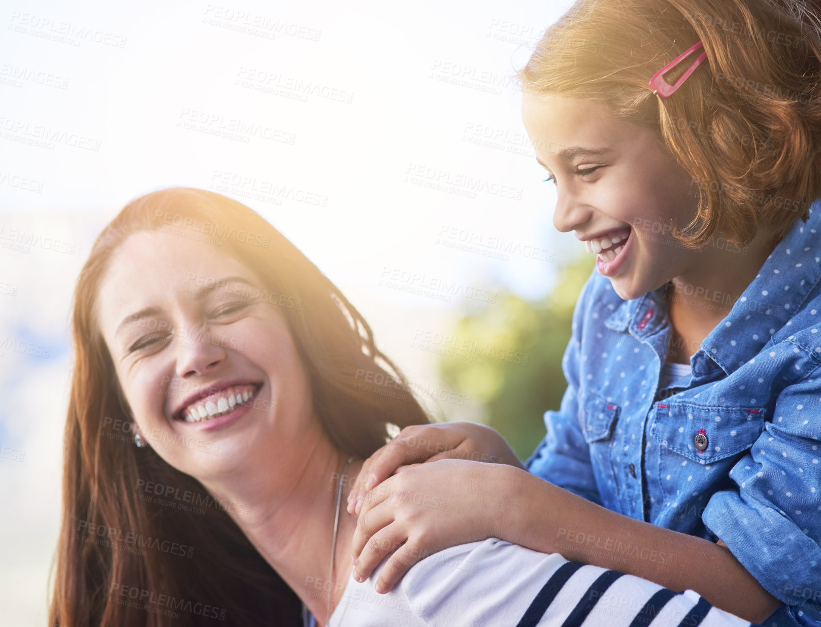 Buy stock photo Shot of a mother giving her daughter a piggyback ride