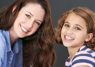 Buy stock photo Mommy, girl and portrait in studio for family, smile and security in love on gray background. Daughter, mother and happy together for trust or support, care and comfort in connection for bonding