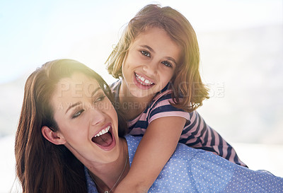 Buy stock photo Shot of a mother giving her daughter a piggyback ride