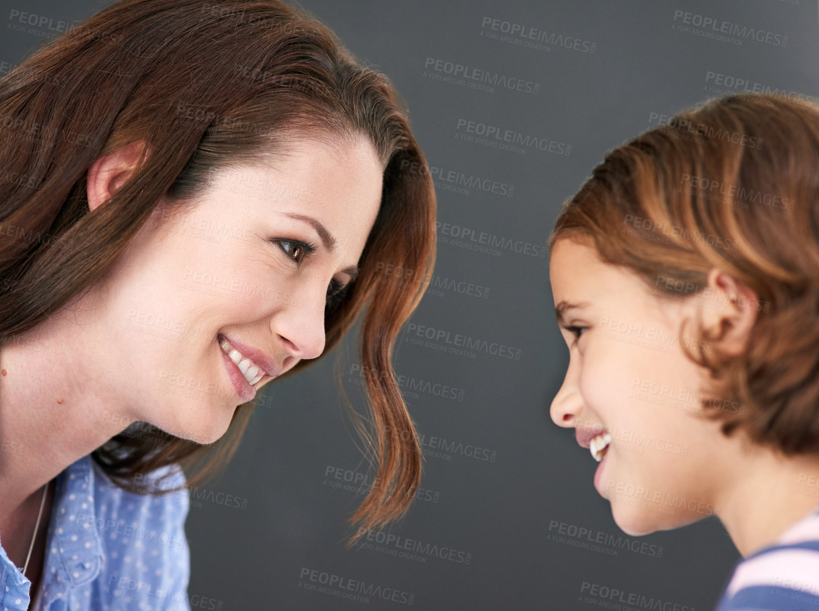 Buy stock photo Mommy, girl and profile in studio for family, smile and security in love on gray background. Daughter, mother and happy together for trust or support, care and comfort in connection for bonding